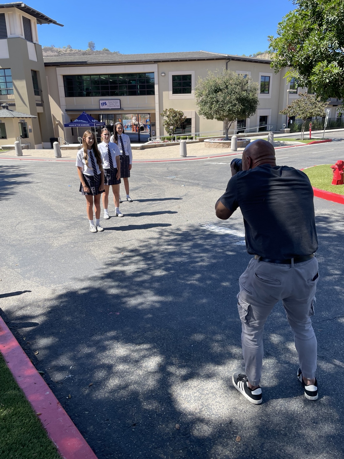 Photographer working with students on location at a school